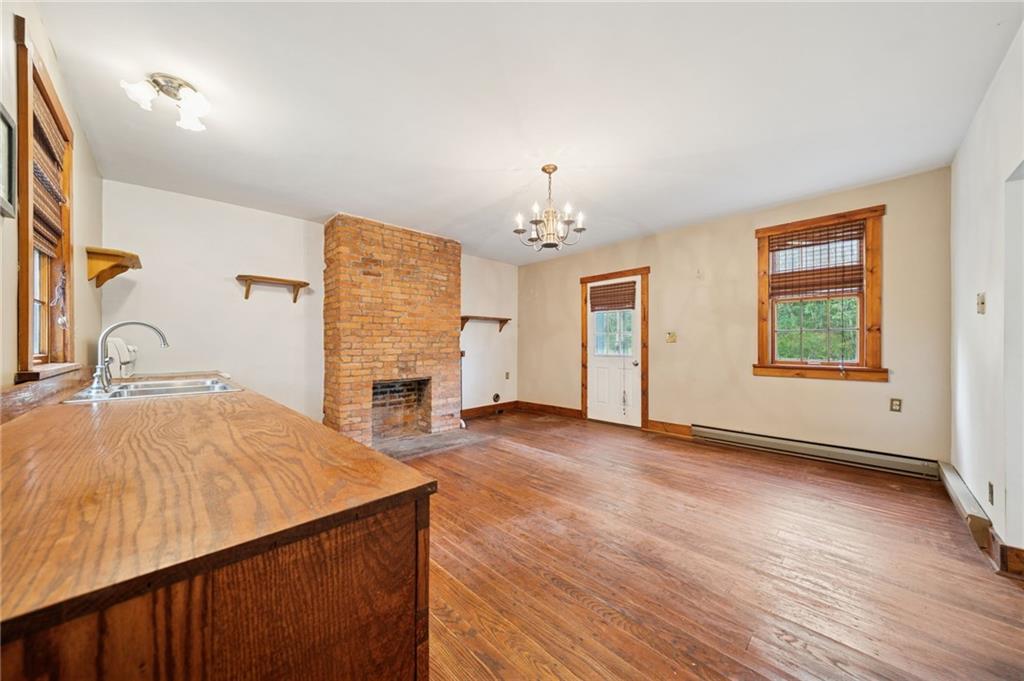 41 Columbia Road Monongahela, PA 15063 - Photo 14 of 37 an empty room with a fireplace and wooden floor