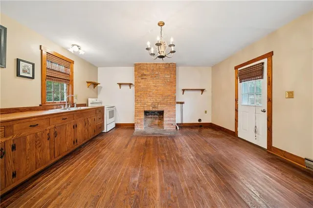 a view of hallway with livingroom and wooden floor