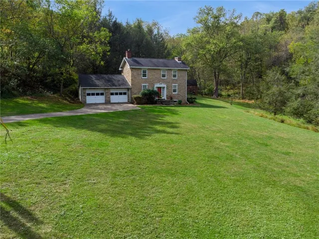 a aerial view of a house with big yard