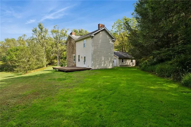 a view of a house with backyard and garden