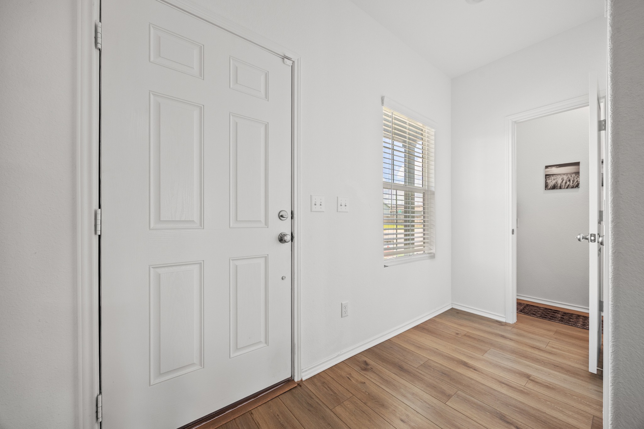14121 Berning Road Manor, TX 78653 - Photo 12 of 27 A welcoming entry features durable wood flooring and a side window, adding natural light.