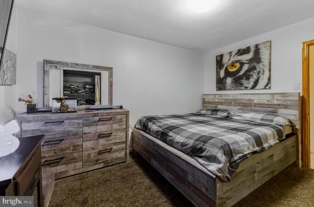 a bedroom with a bed and a dresser in it