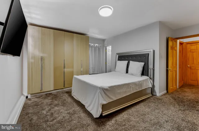 a bed sitting in a room next to a window