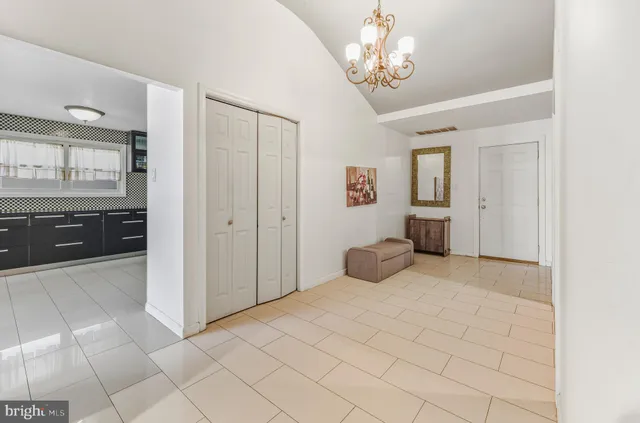 a large bedroom with a bed and a chandelier