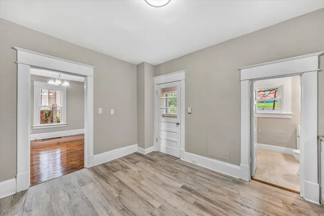 a view of an empty room with wooden floor