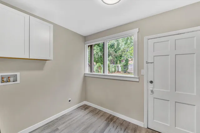 a view of room with hardwood floor and window