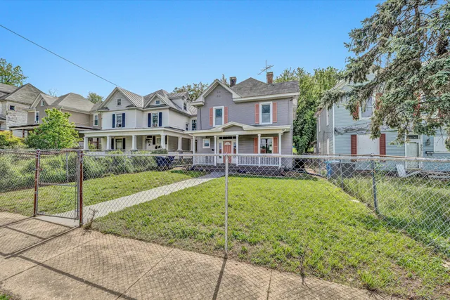 a front view of a house with a yard table and chairs