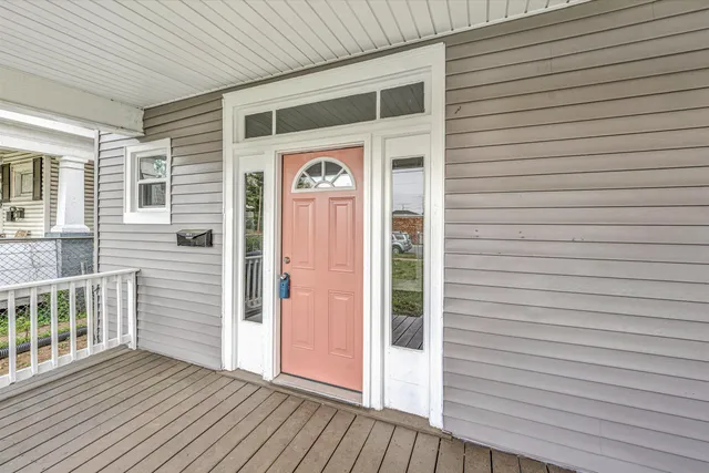 a view of a house with wooden deck