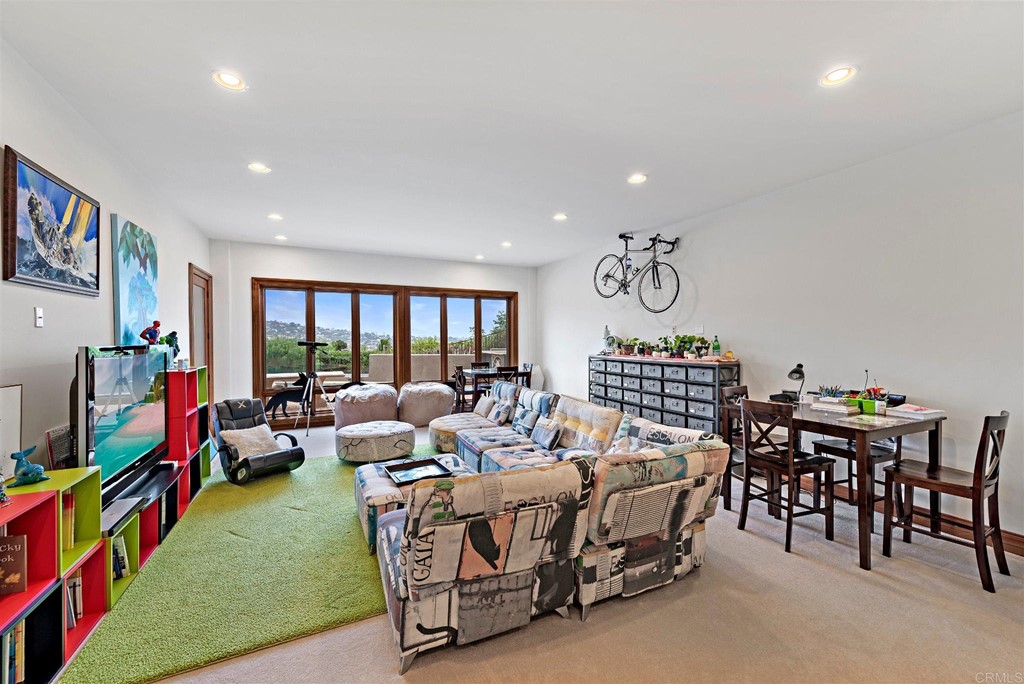 8606 Ruette Monte Carlo La Jolla, CA 92037 - Photo 12 of 13 a living room with furniture and a flat screen tv