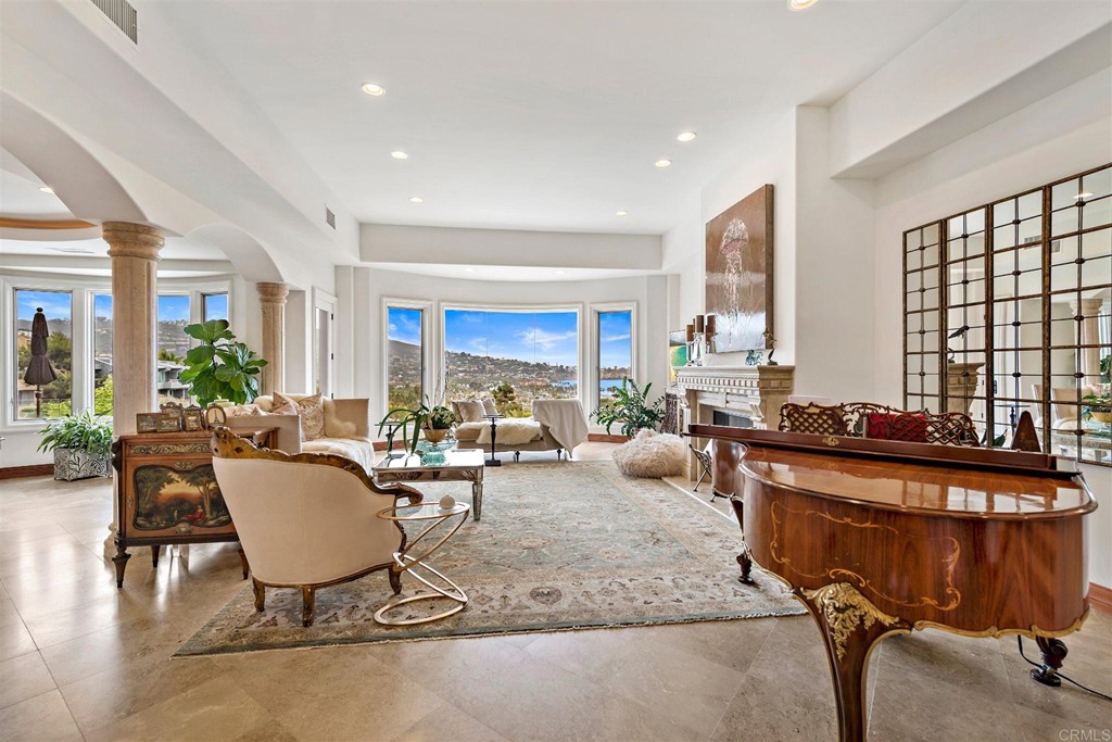 8606 Ruette Monte Carlo La Jolla, CA 92037 - Photo 4 of 13 a living room with furniture a flat screen tv and large windows