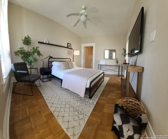 a bedroom with a bed lamps and fireplace