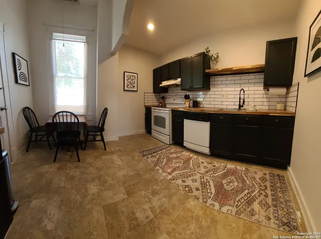 a view of a kitchen with kitchen island granite countertop furniture a sink and a microwave
