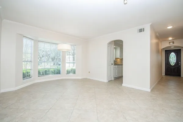 an empty room with windows and bathroom view