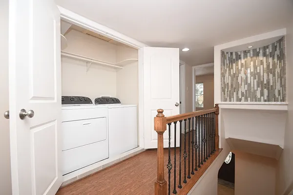 a bedroom with a large bed and a potted plant