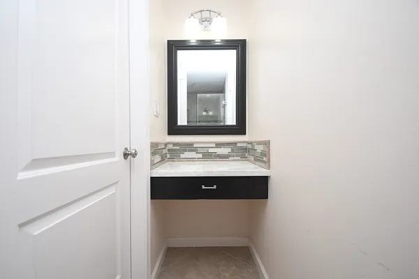 a bedroom with a large bed and a potted plant