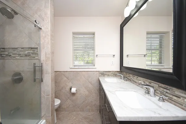 a bathroom with a glass shower door
