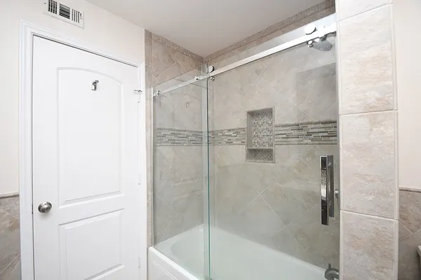 a bathroom with a sink a mirror and a shower