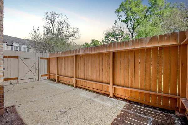 a view of a backyard with wooden fence