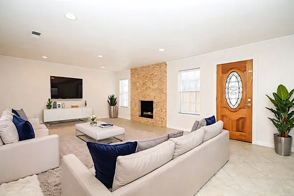 a living room with furniture fireplace and a flat screen tv