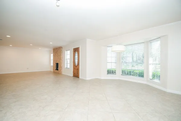 a view of an empty room with glass door and exposed radiator