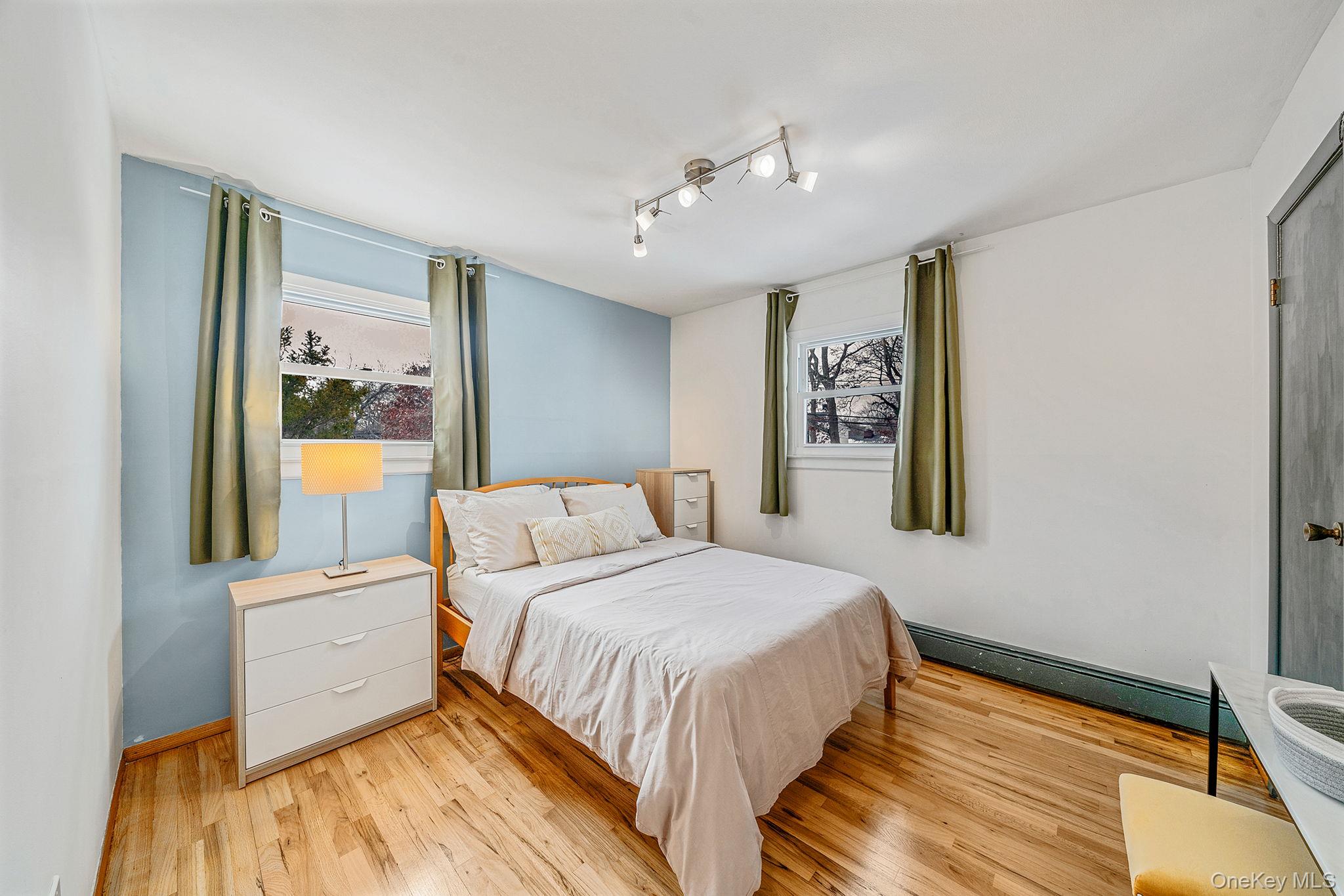 1663 Claas Avenue Holbrook, NY 11741 - Photo 13 of 28 a bedroom with a large bed and a window