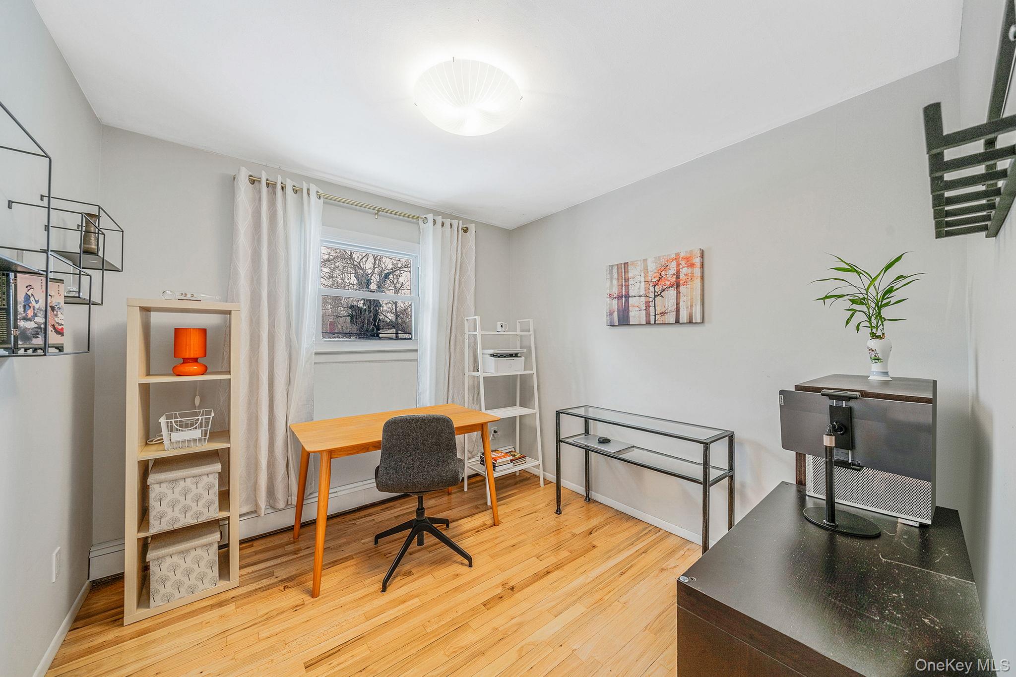 1663 Claas Avenue Holbrook, NY 11741 - Photo 14 of 28 a view of a workspace with furniture and a potted plant