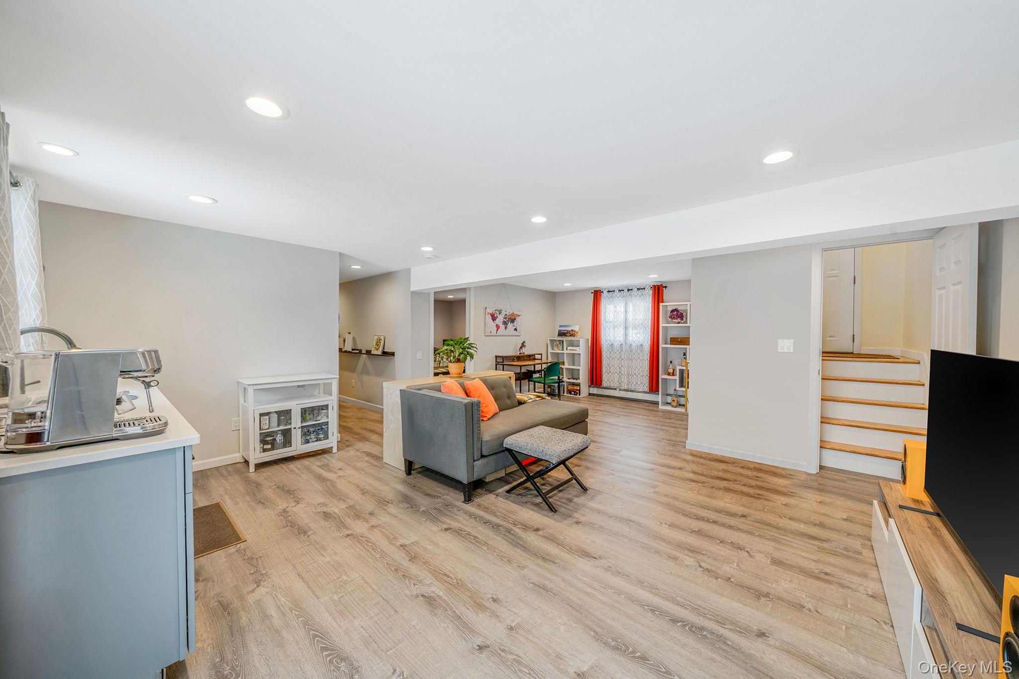 1663 Claas Avenue Holbrook, NY 11741 - Photo 16 of 28 a living room with furniture and a flat screen tv