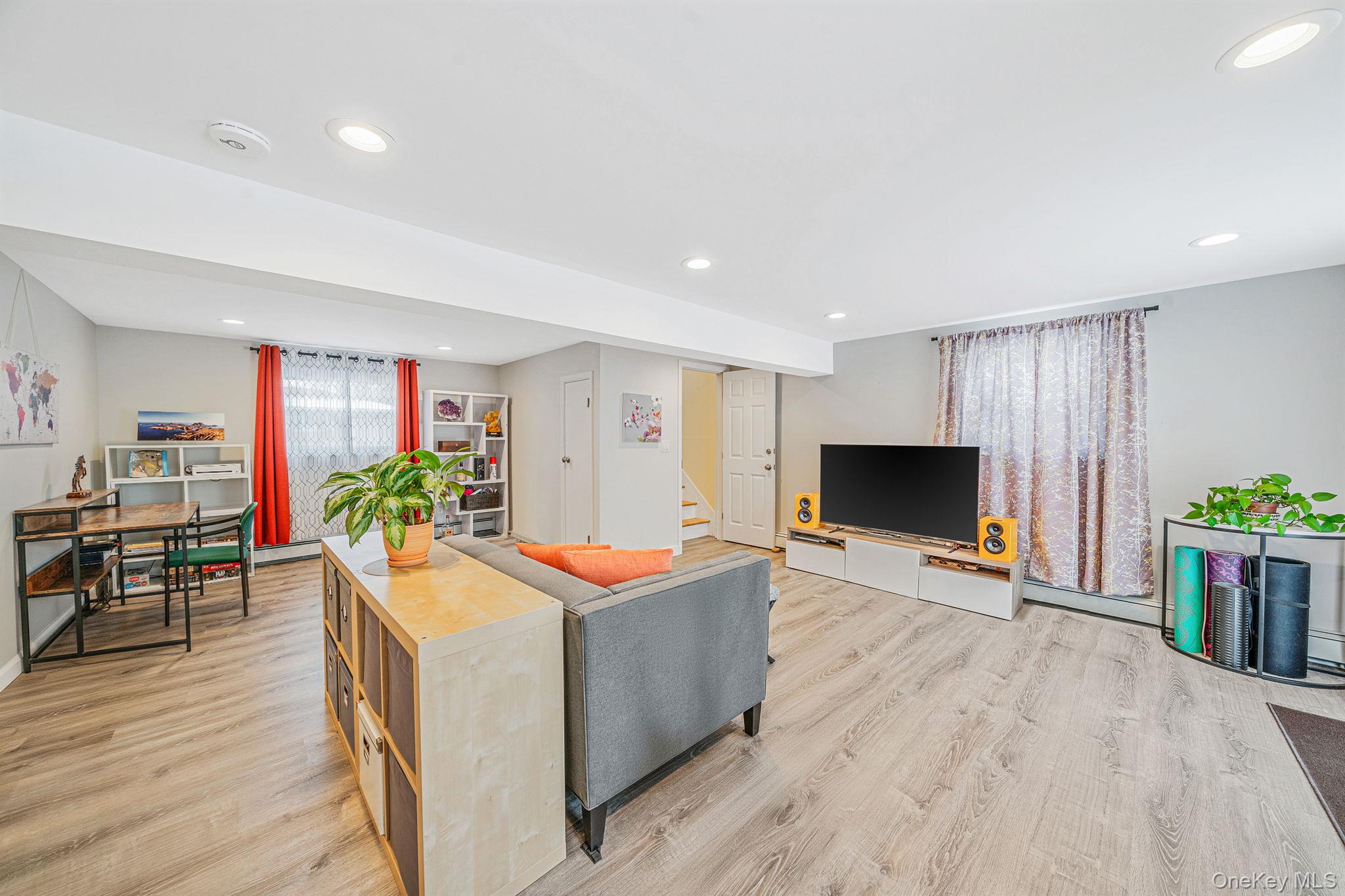 1663 Claas Avenue Holbrook, NY 11741 - Photo 17 of 28 a living room with furniture a flat screen tv and a dining table