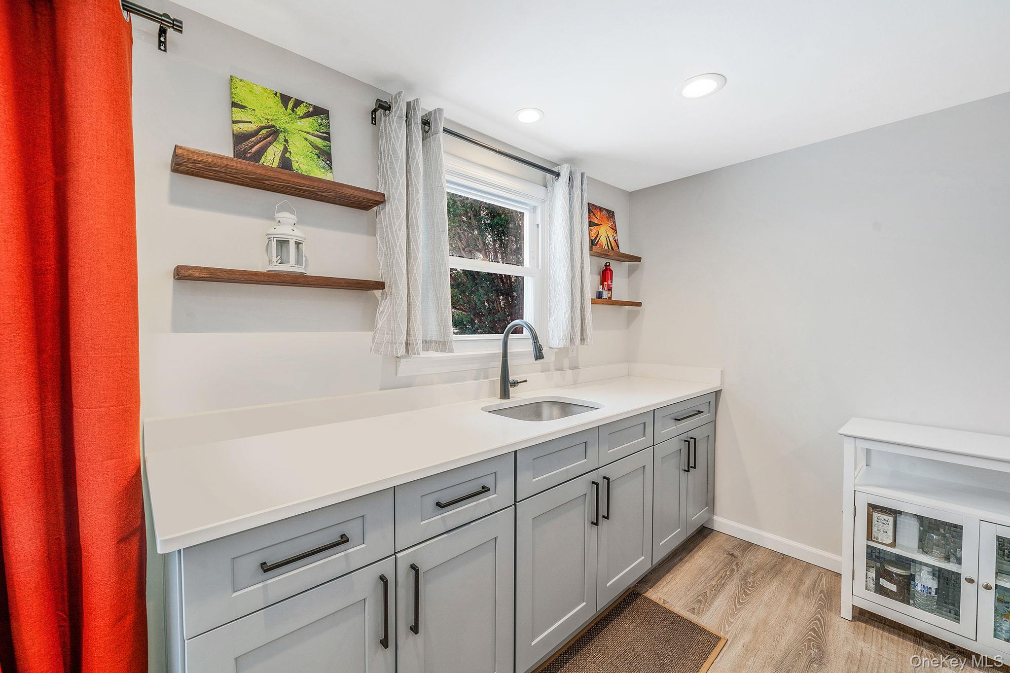 1663 Claas Avenue Holbrook, NY 11741 - Photo 18 of 28 a kitchen with a sink and a stove top oven