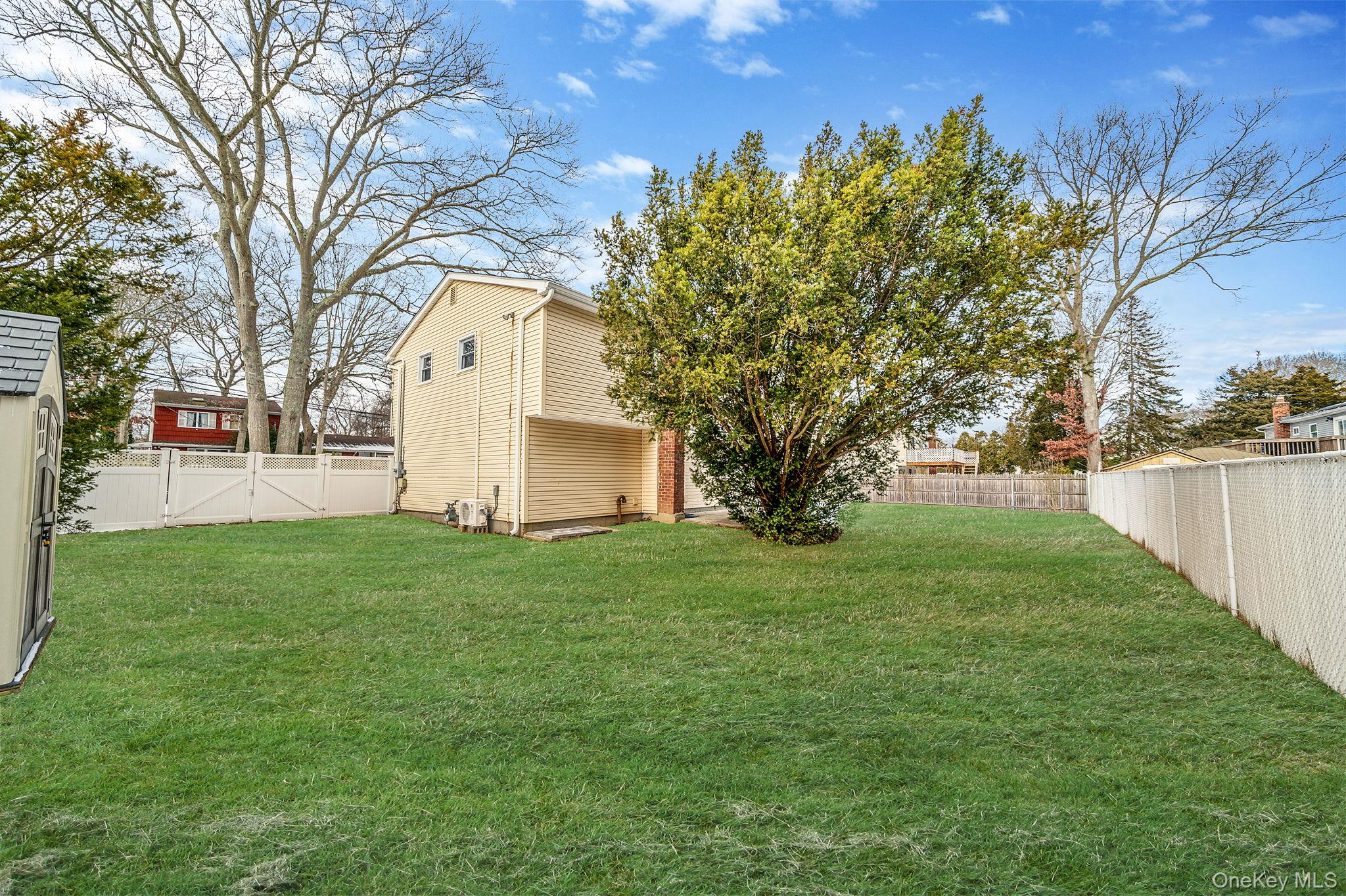 1663 Claas Avenue Holbrook, NY 11741 - Photo 25 of 28 a view of a backyard with large trees