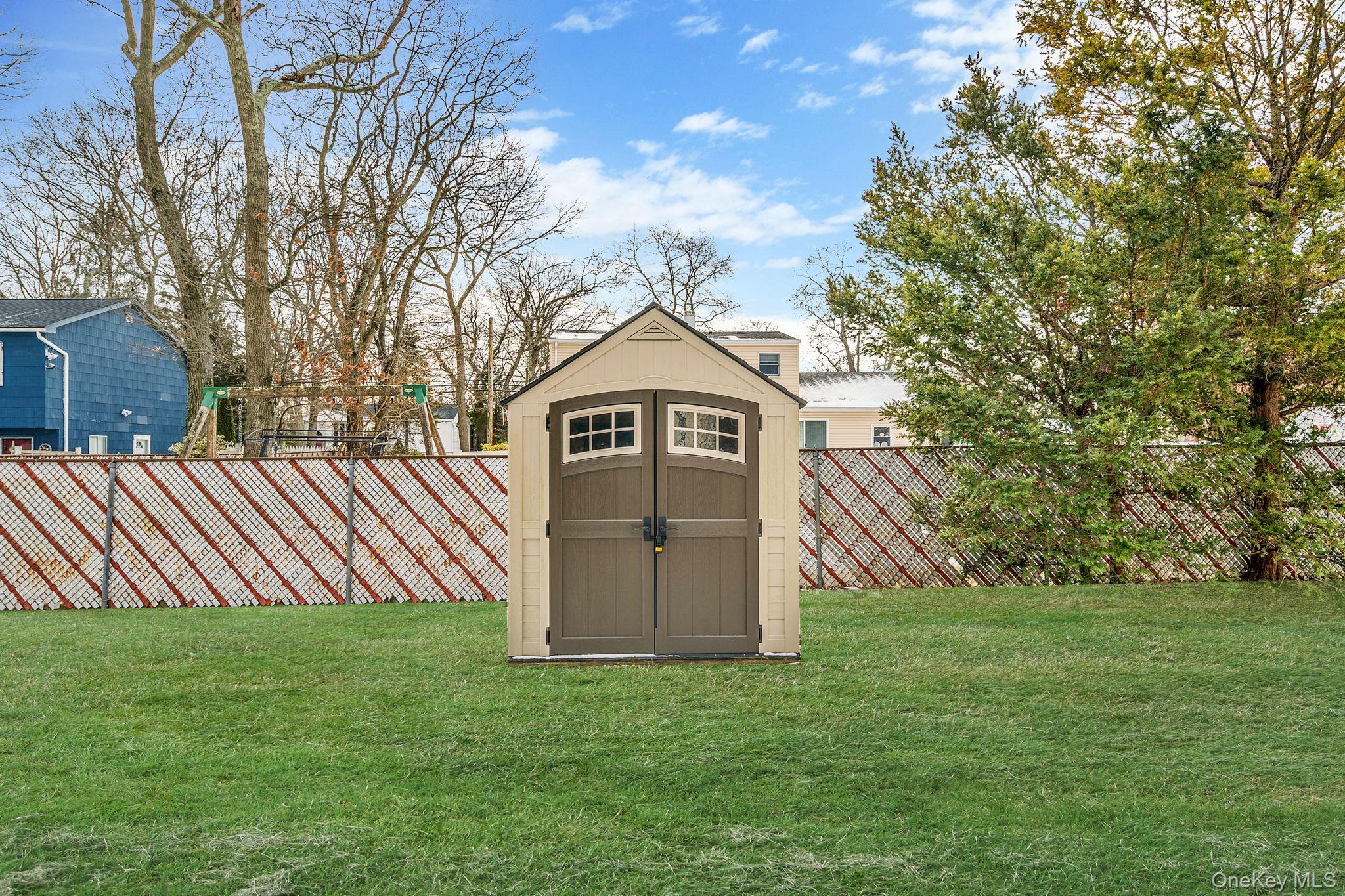 1663 Claas Avenue Holbrook, NY 11741 - Photo 26 of 28 a backyard of a house with lots of green space