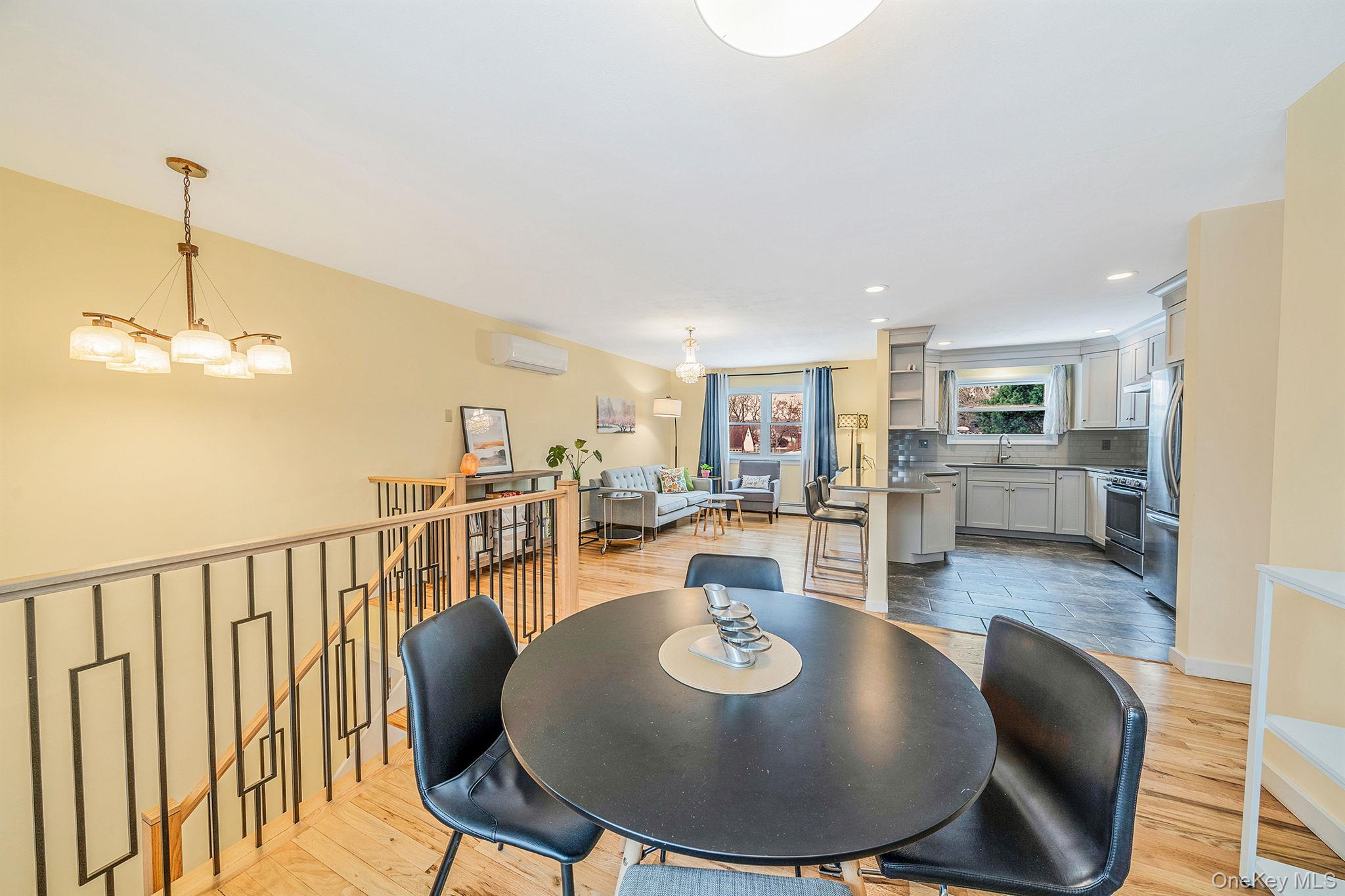 1663 Claas Avenue Holbrook, NY 11741 - Photo 8 of 28 a dining room with furniture wooden floor and a chandelier
