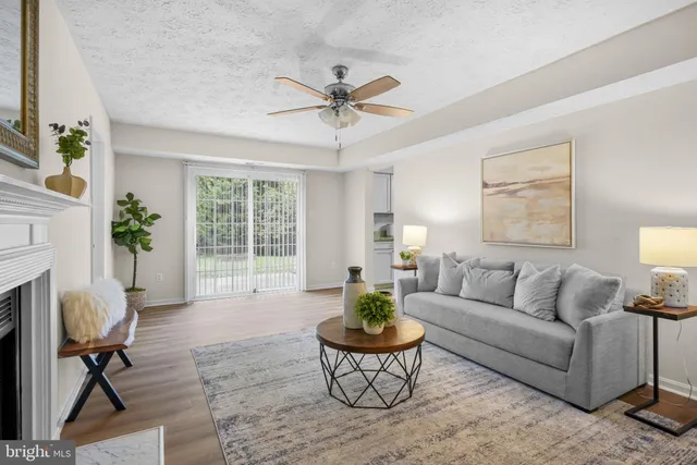 a living room with furniture a fireplace and a table