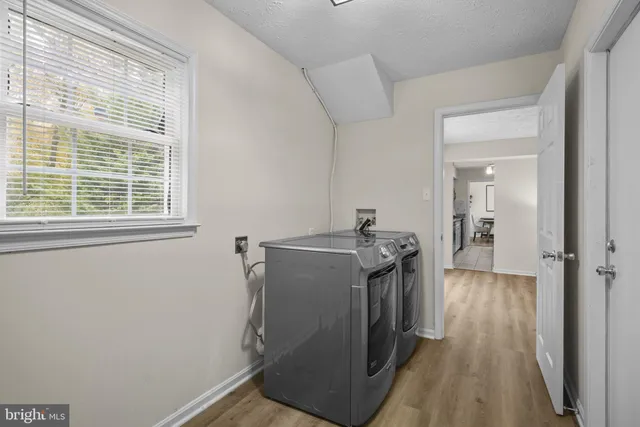 a view of hallway with wooden floor