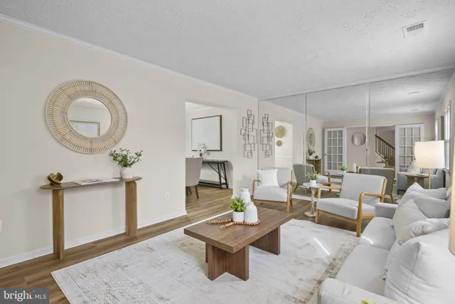 a living room with furniture a rug and a chandelier