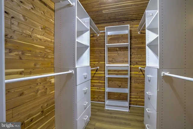 a view of walk in closet with clothes