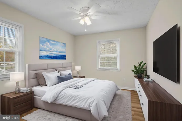 a bedroom with a large bed and a flat screen tv