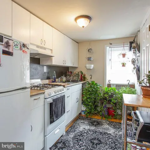 a kitchen with stainless steel appliances granite countertop a refrigerator a stove and a sink