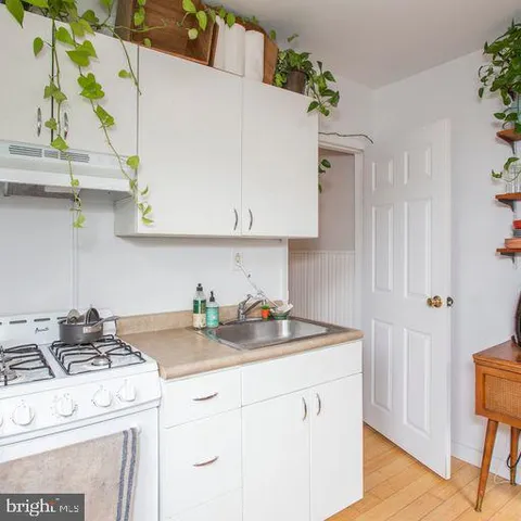 a kitchen with wooden cabinets and sink