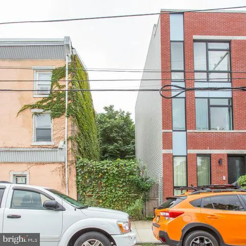 a front view of a house with a road