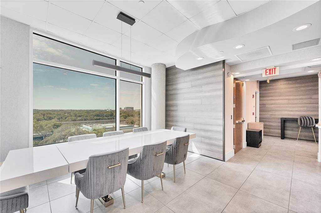 525 East Jackson Street Orlando, FL 32801 - Photo 18 of 65 a dining hall with stainless steel appliances kitchen island granite countertop a table chairs and a glass door