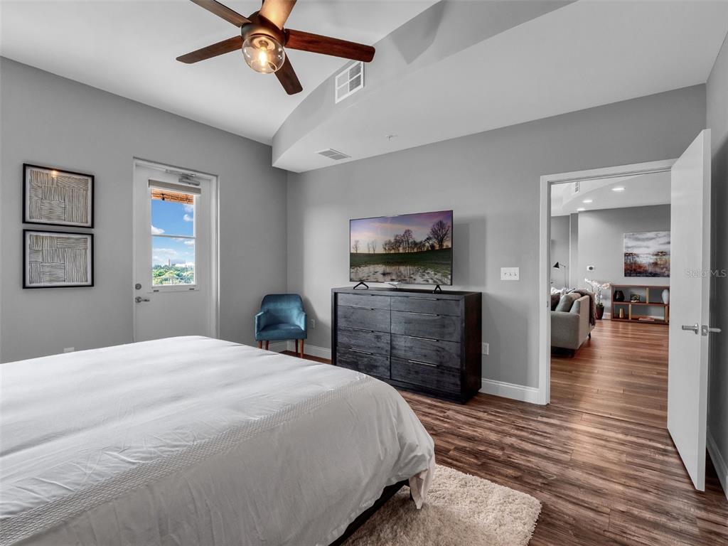 525 East Jackson Street Orlando, FL 32801 - Photo 23 of 65 a bedroom with a bed and a flat tv screen on dresser