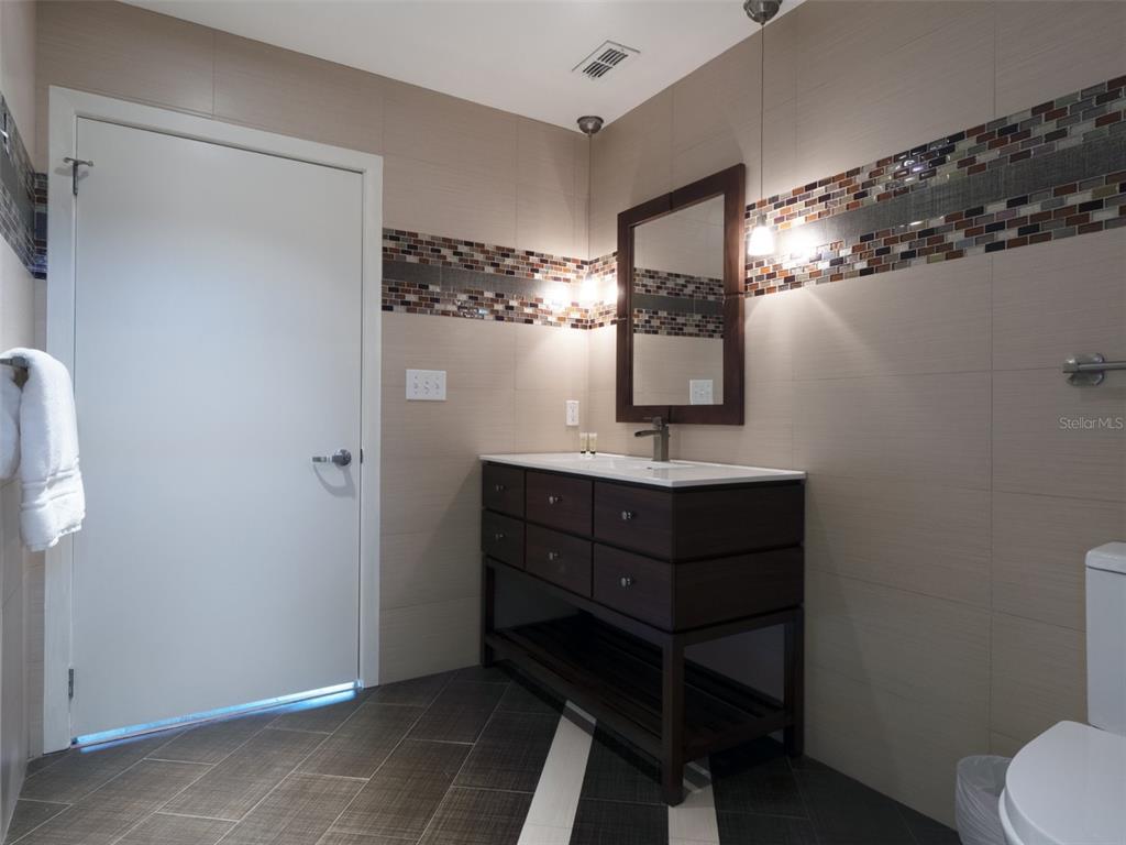 525 East Jackson Street Orlando, FL 32801 - Photo 30 of 65 a bathroom with a sink vanity and mirror