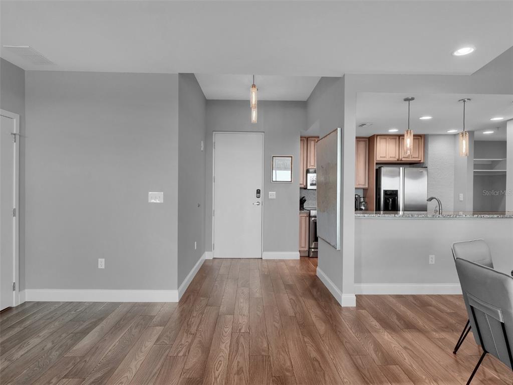 525 East Jackson Street Orlando, FL 32801 - Photo 32 of 65 a view of a hallway with wooden floor and a cabinet