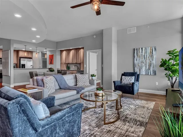 a kitchen with stainless steel appliances granite countertop a refrigerator a stove a sink and a microwave