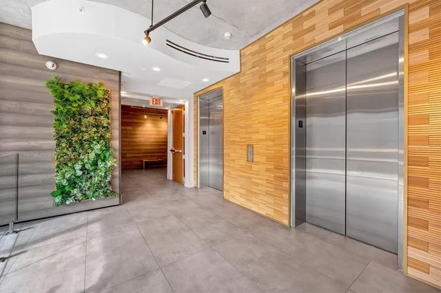 a view of a hallway with wooden floor and furniture