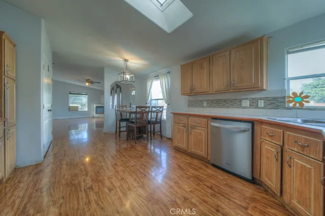 a kitchen with wooden floors and wooden cabinets