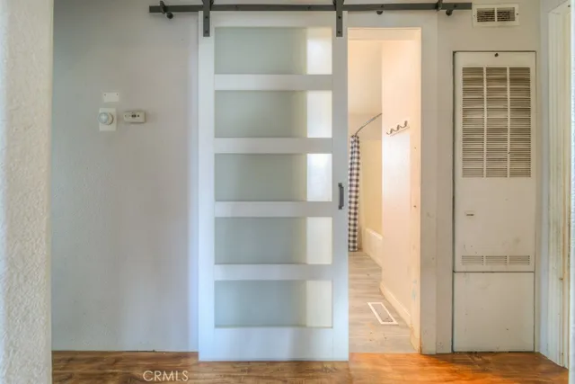 a view of a room with wooden floor and closet
