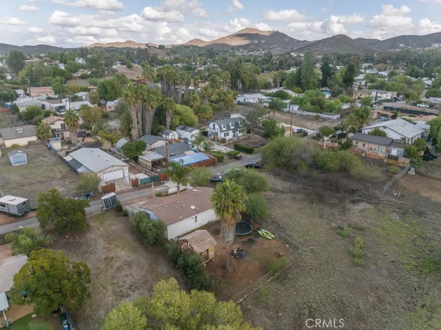 an aerial view of a house with a street
