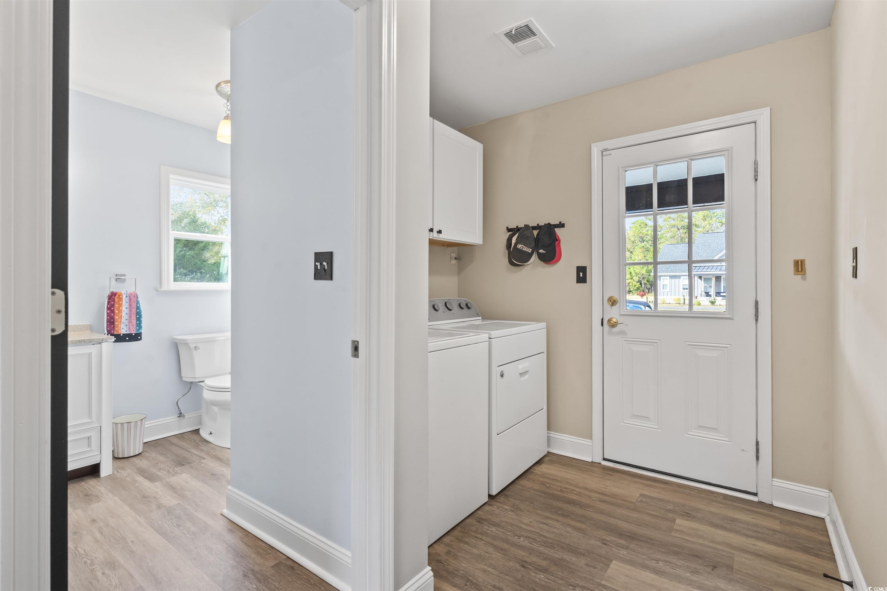1495 Wilderness Lane Loris, SC 29569 - Photo 11 of 37 Laundry area with plenty of natural light, light wood finished floors, and separate washer and dryer